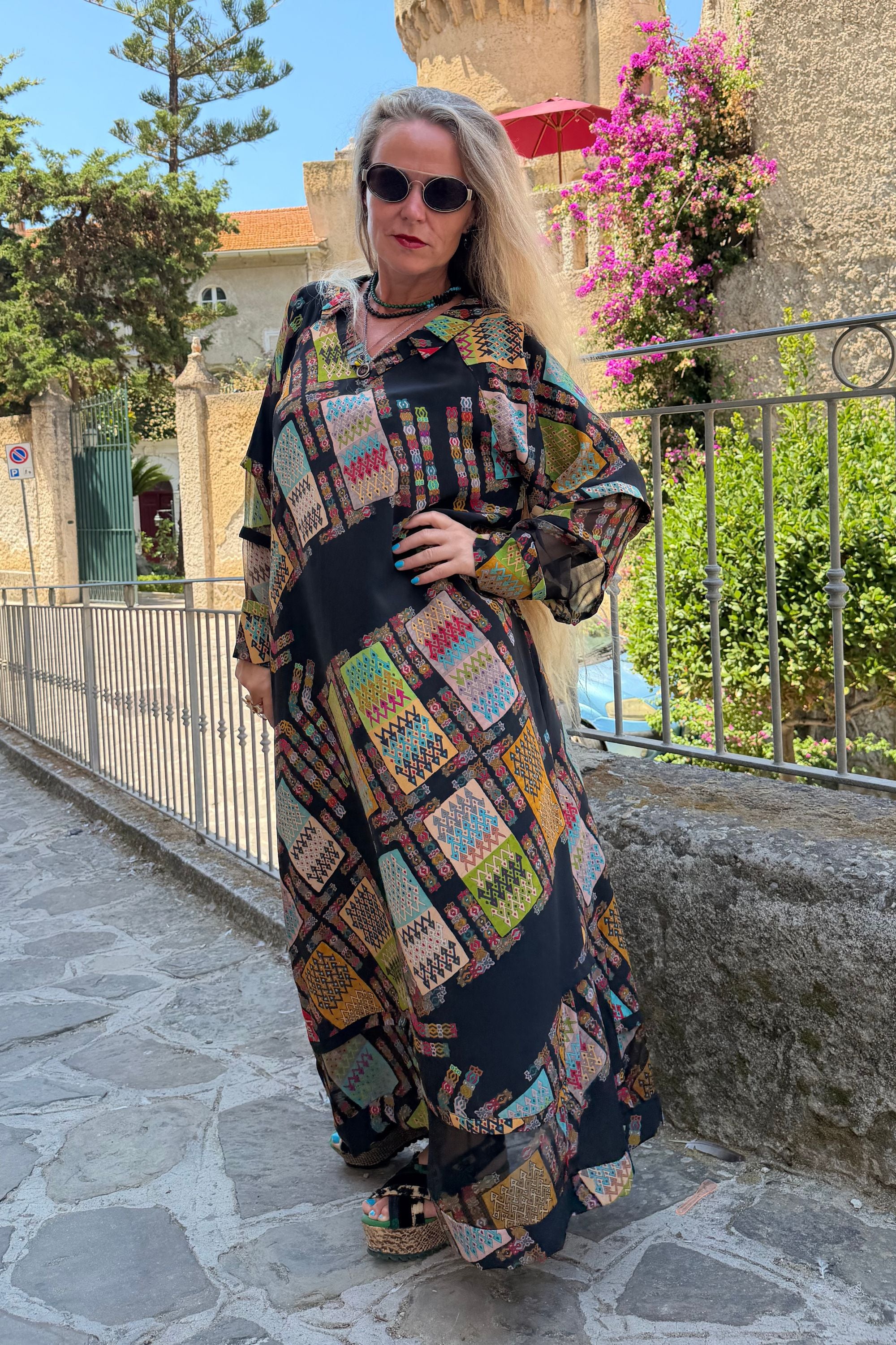 Outdoor front view of Andrilla Harly Black maxi dress with colourful geometric print