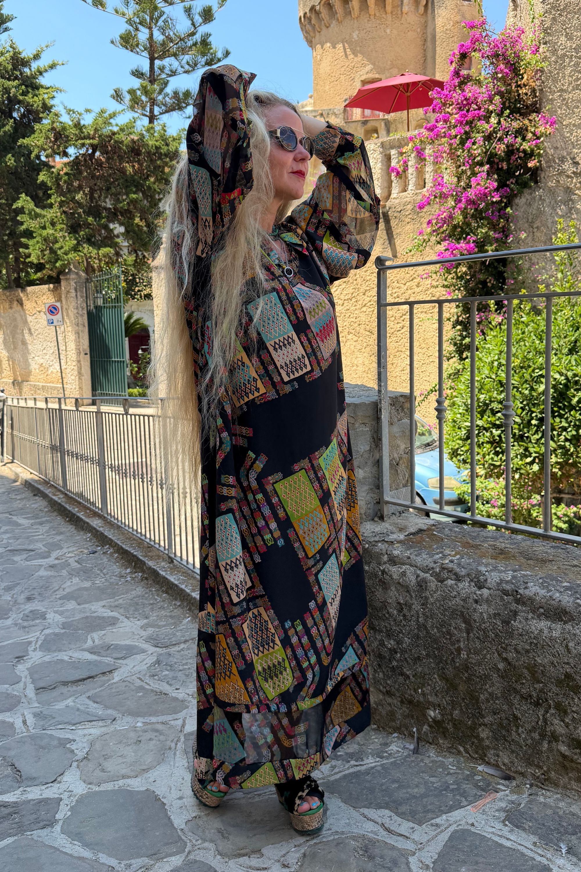 Full-length outdoor view of Andrilla silk maxi dress in Harly Black with long sleeves