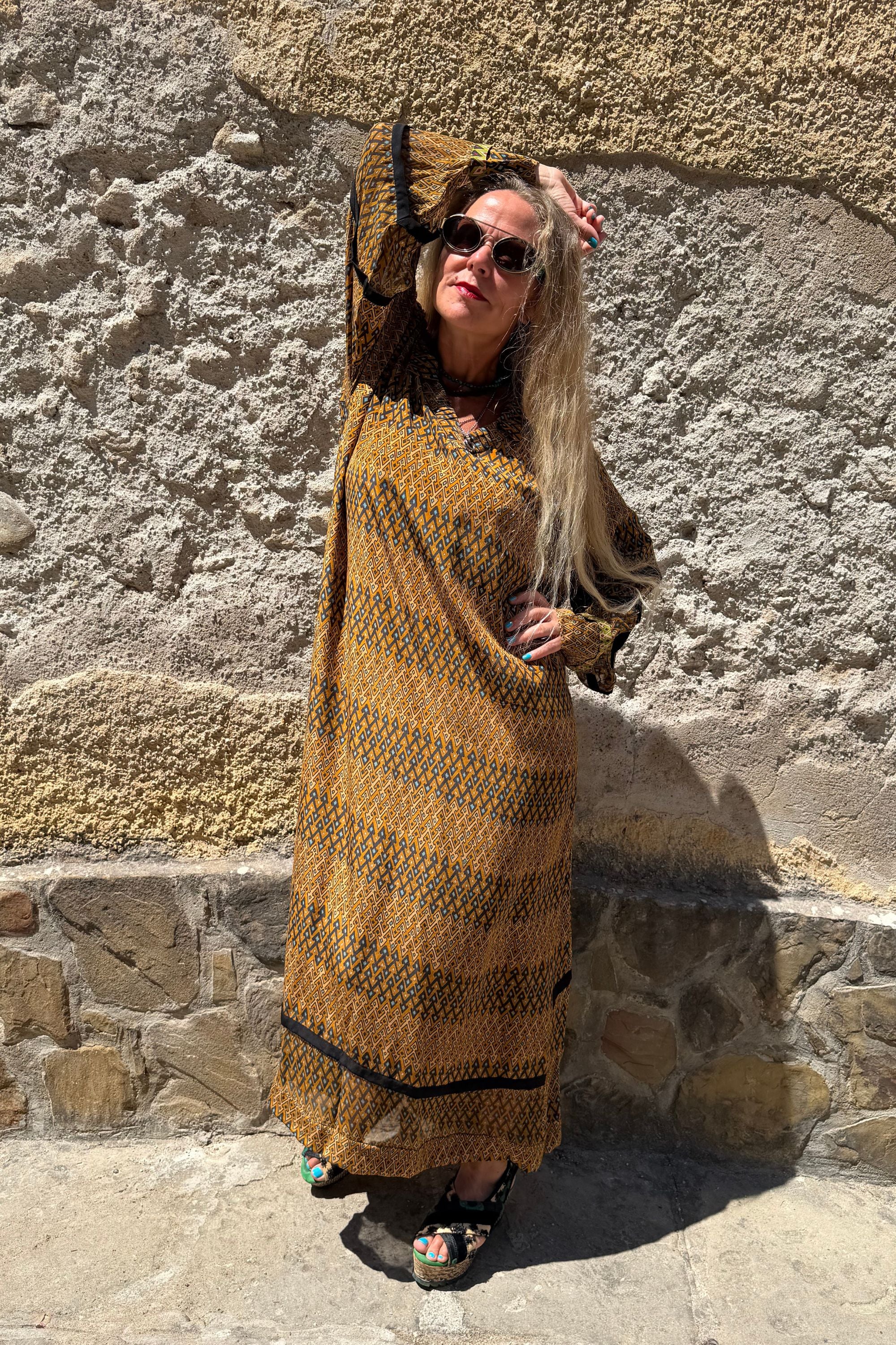 Side view of Andrilla Sporrof Brown silk maxi dress showing the relaxed fit and semi-sheer sleeve details