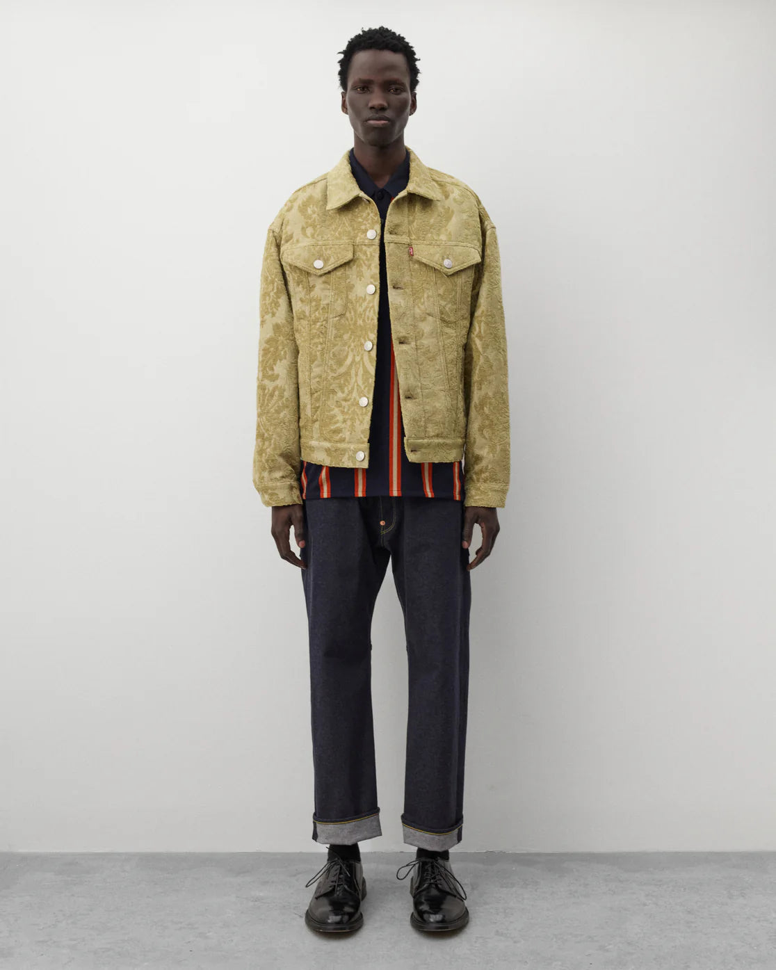 Full look
Junya Watanabe Man Striped Knit Polo in navy and orange styled with grey trousers and black leather shoes