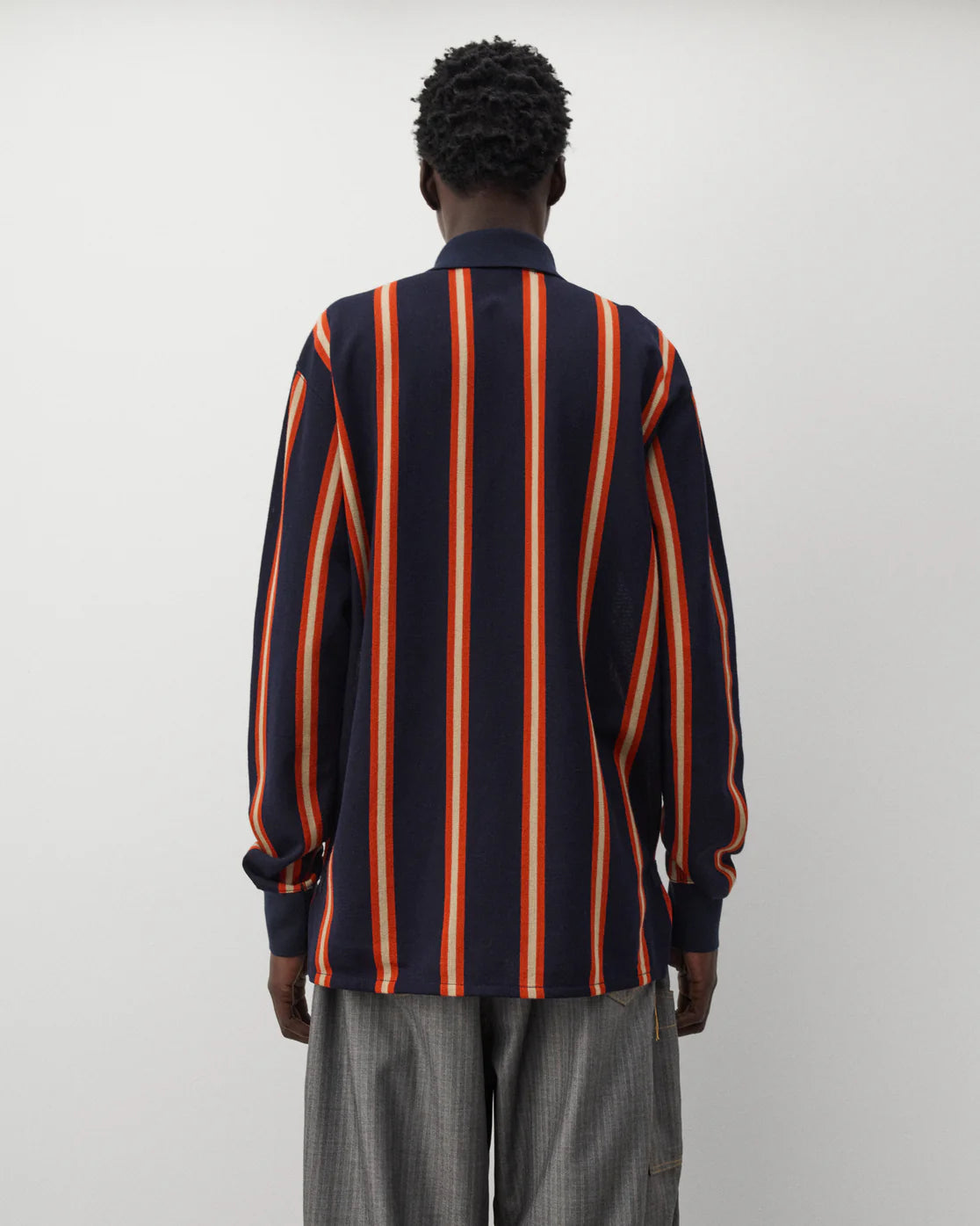 Back worn
Junya Watanabe Man Striped Knit Polo in navy and orange shown from the back