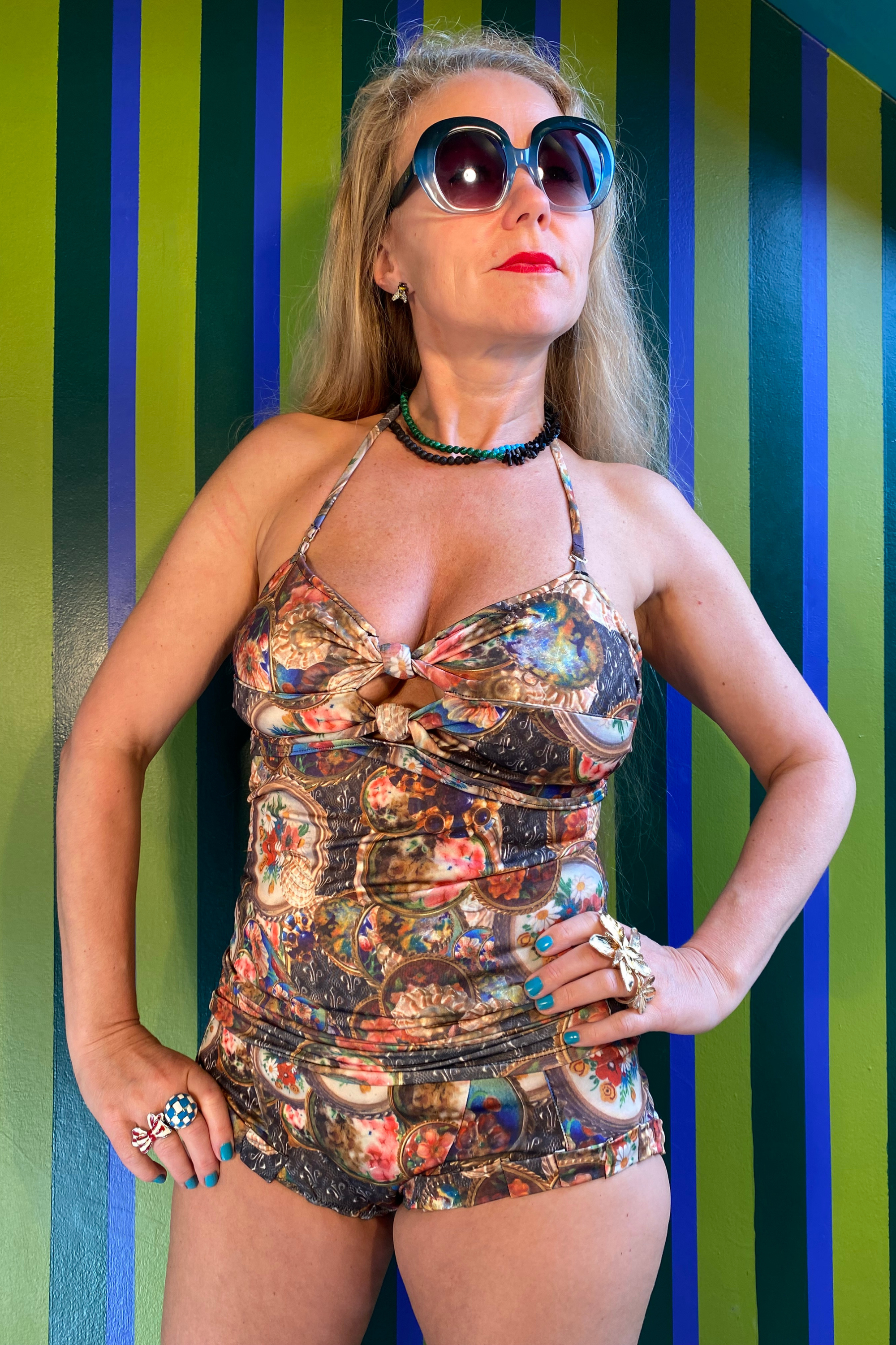Kron by Kronkron Pam Long Bikini Top in Treasurehunt print worn with matching bikini bottoms against a striped green and blue background