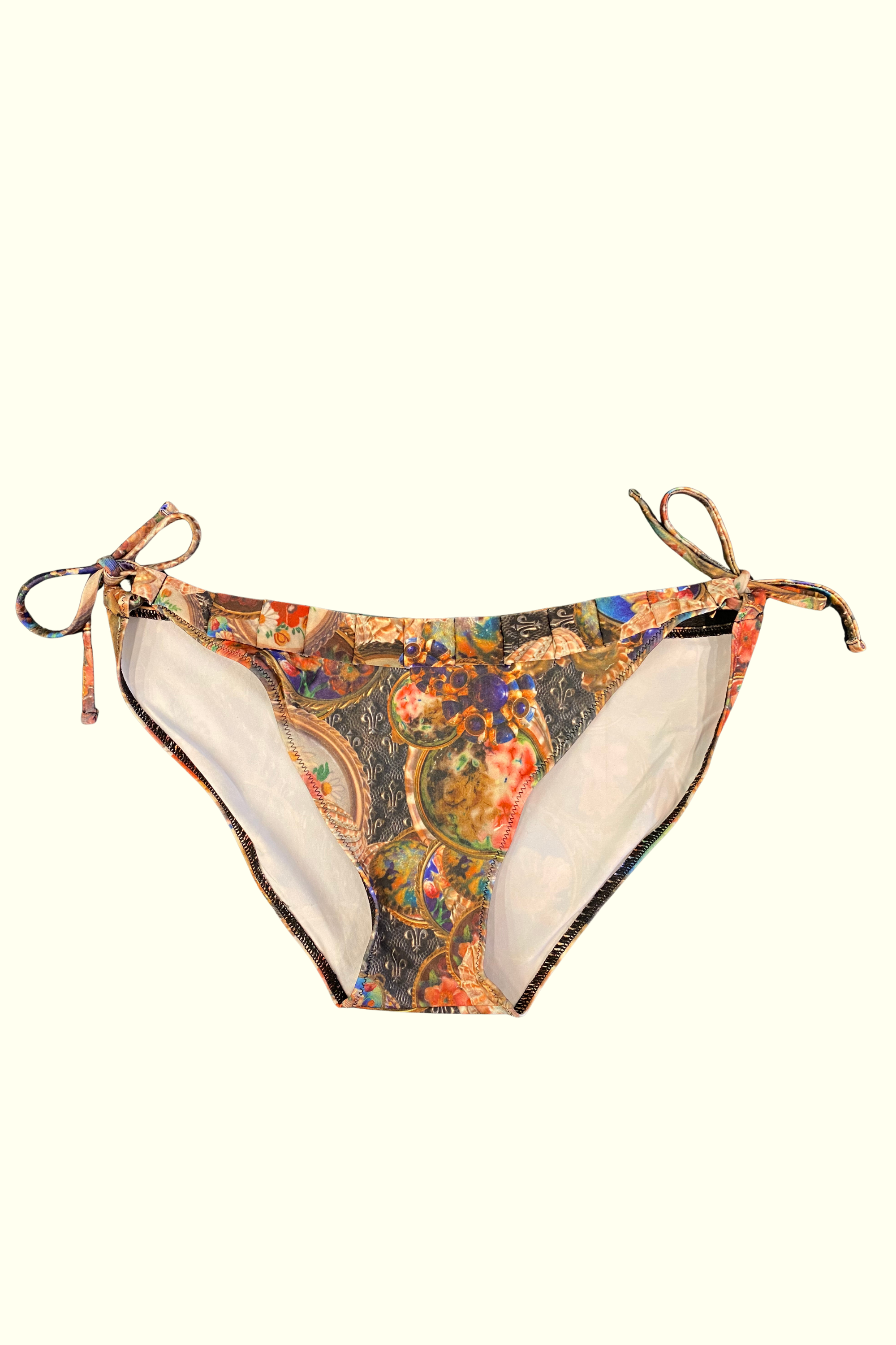 Kron by Kronkron Trixy Triangle Bikini Bottom in Treasurehunt print with adjustable side ties and pleated waist detail