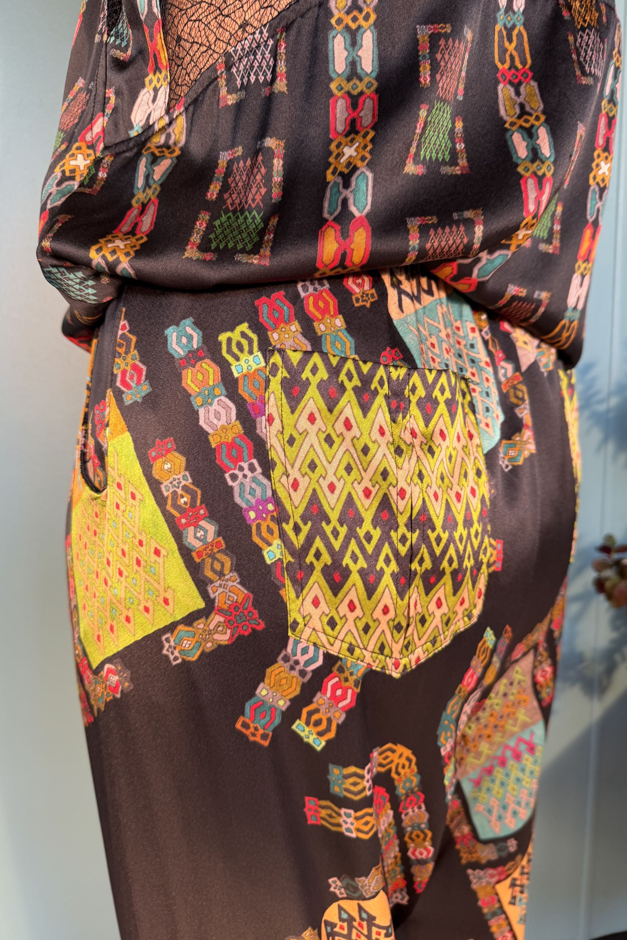 Close-up of the back patch pocket and Harly Black print on Zahara silk trousers