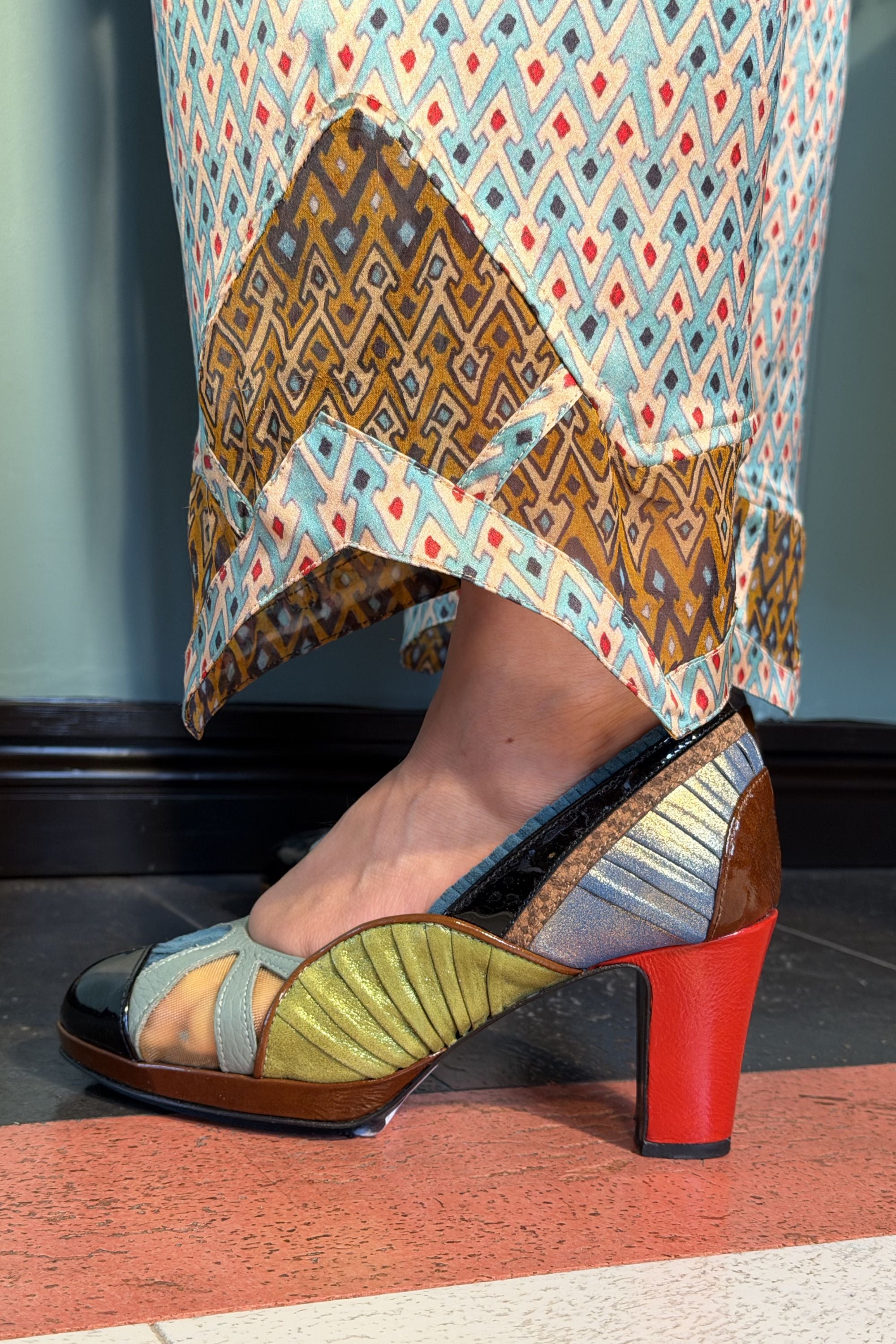 Close-up of semi-sheer Sporrof Brown silk panels at the hems of Zahara Sporrof Blue trousers