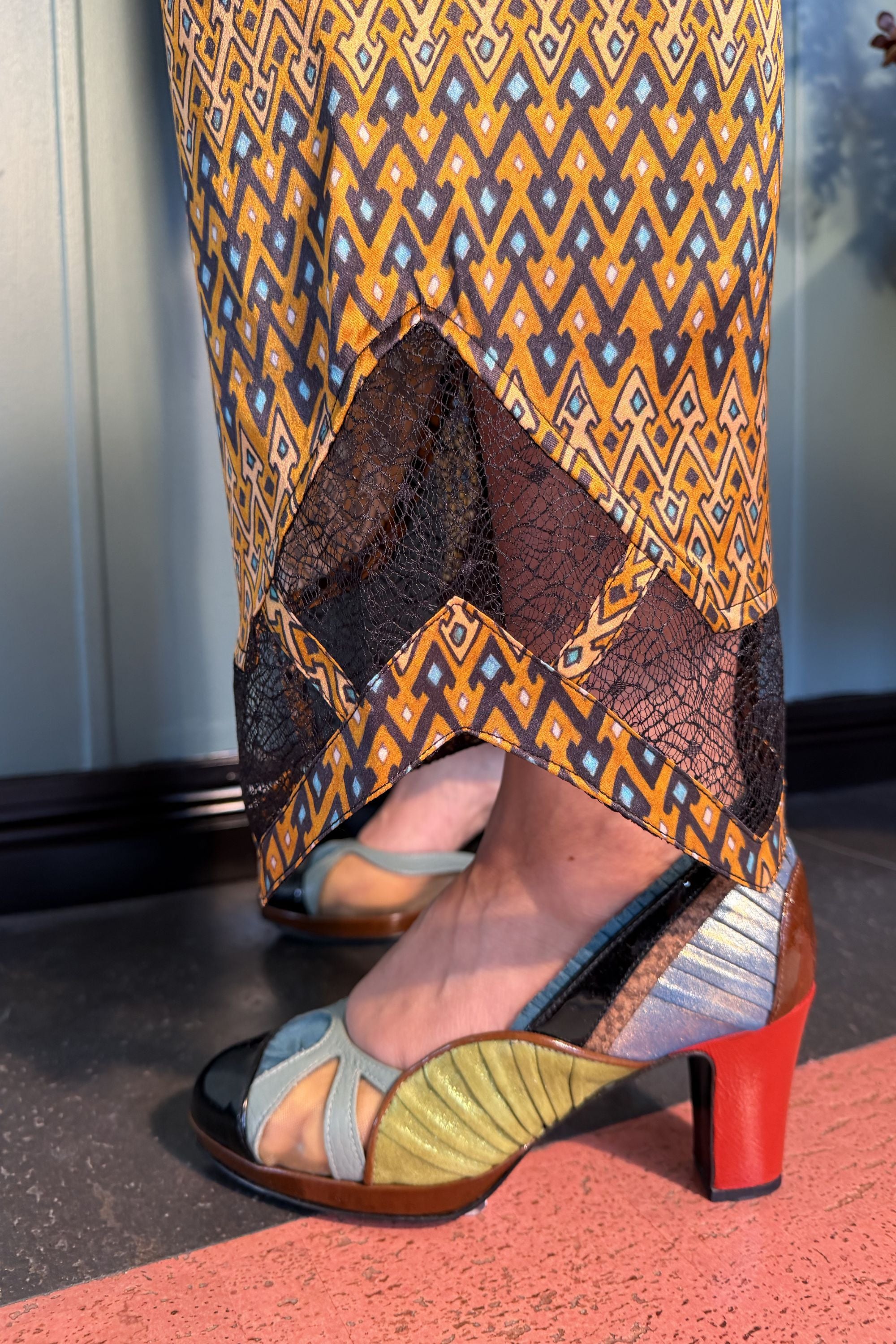 Close-up of black lace inserts at the hems of Zahara Sporrof Brown silk trousers