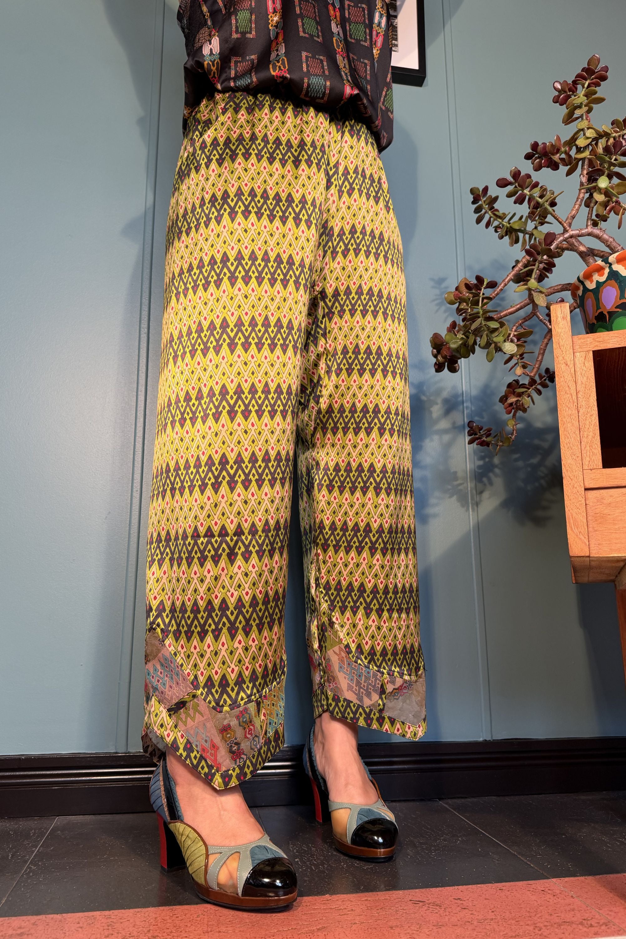 Front view of Kron by Kronkron Zahara silk trousers in Sporrof Green print