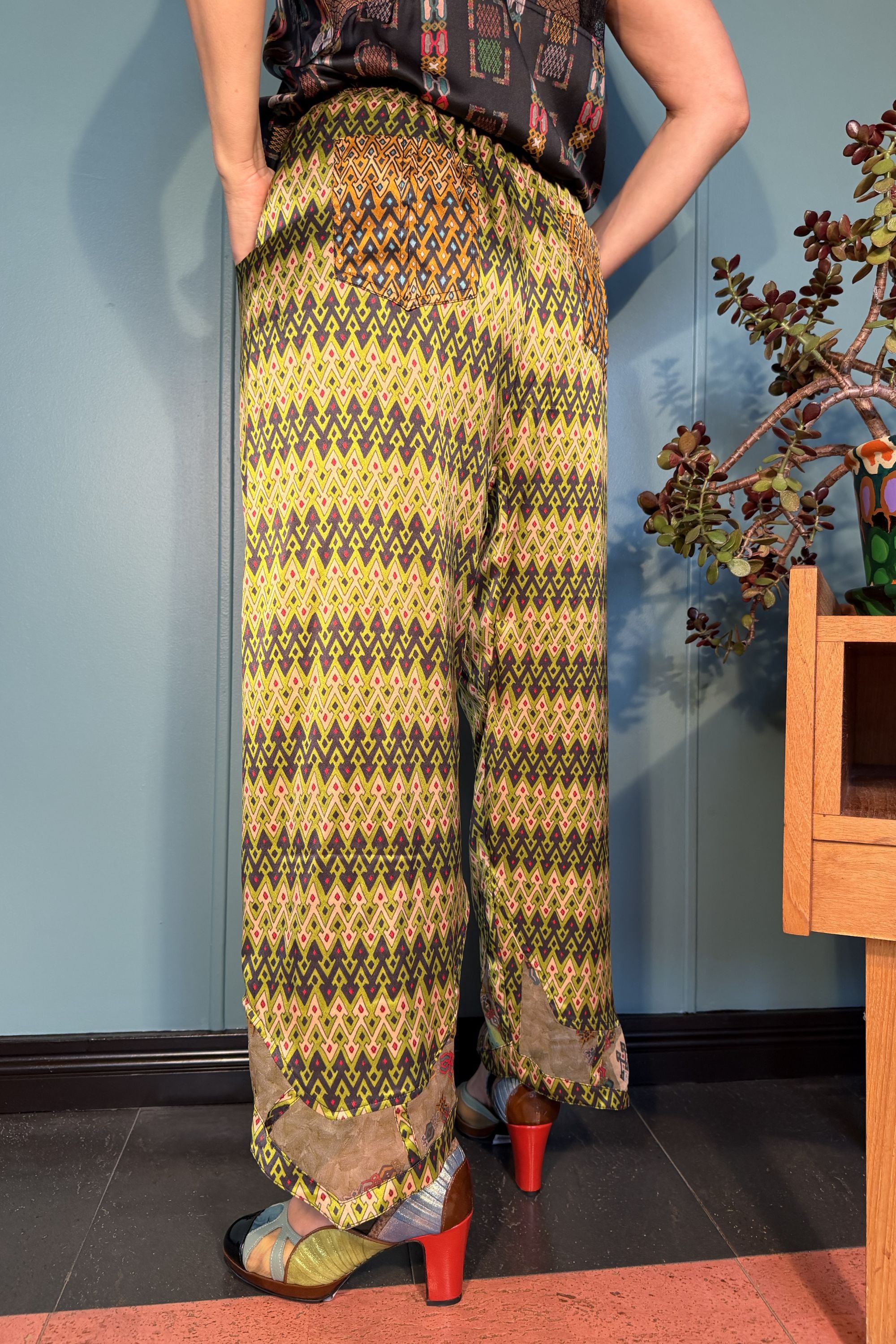 Back view of Zahara Sporrof Green silk trousers showing contrasting patch pockets