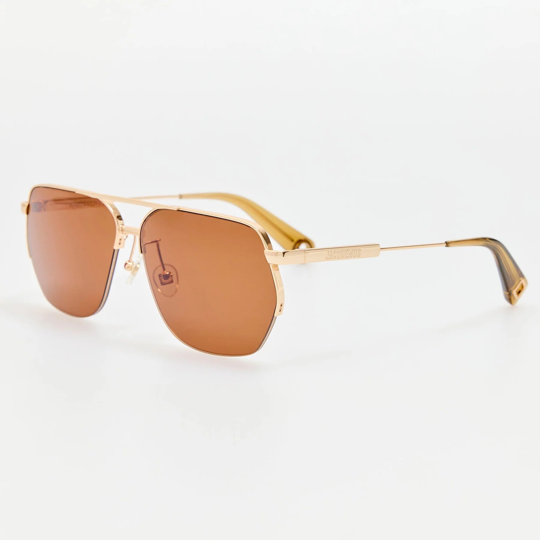Jacquemus Aviador sunglasses in light gold with brown lenses, angled view