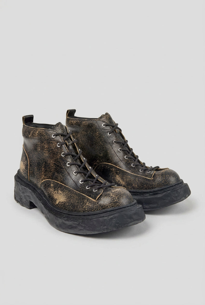 Angled view of CamperLab Vamonos black and brown leather ankle boots