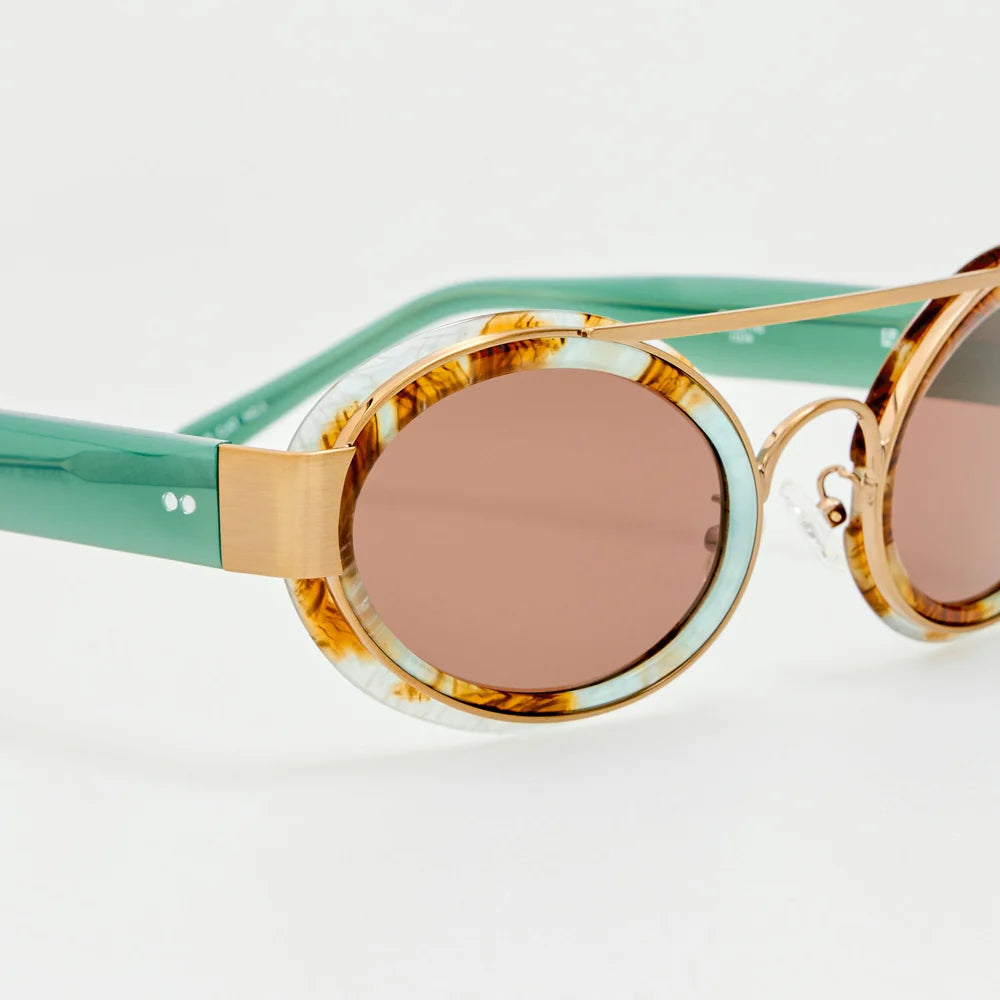 Close-up of Dries Van Noten marble cat-eye sunglasses with brown lenses and antique gold-tone brow bar