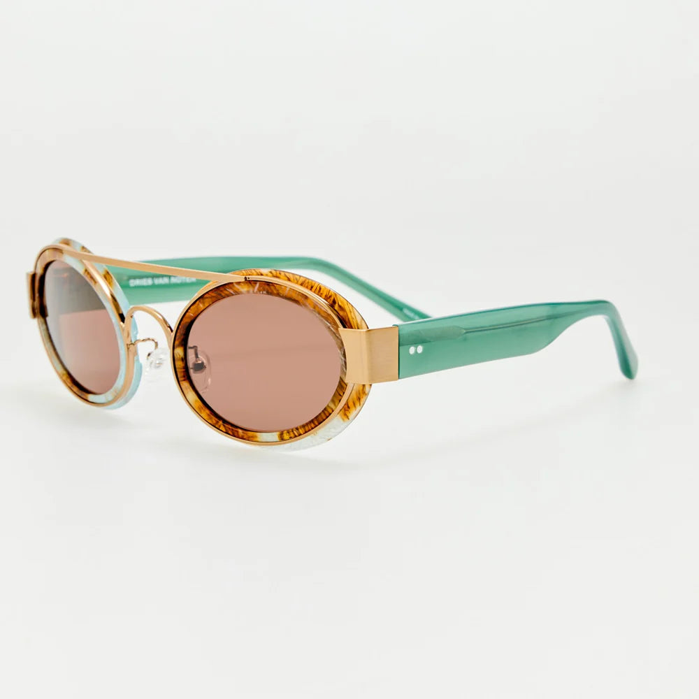 Angled view of Dries Van Noten marble sunglasses with translucent aqua temples