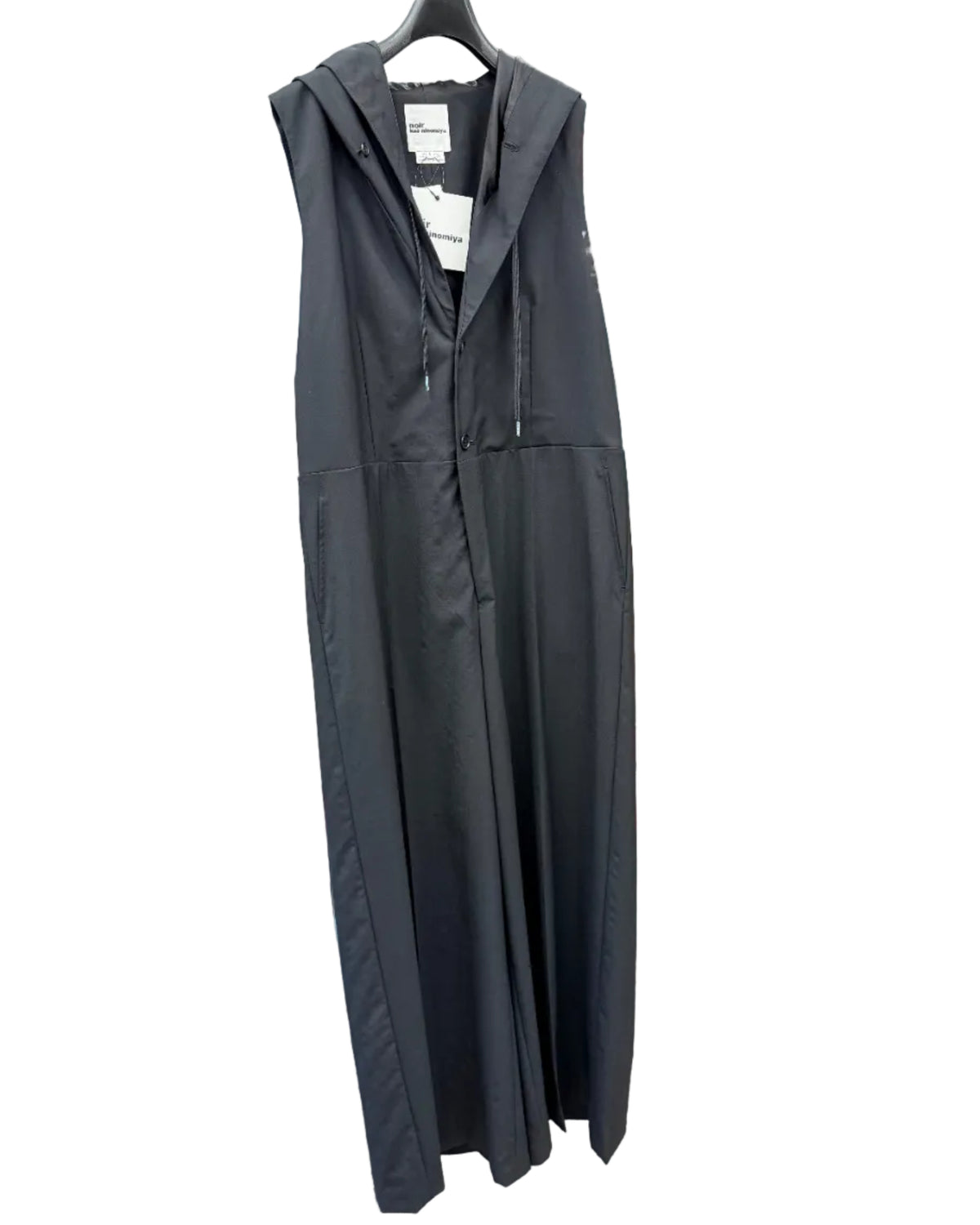 Front view of noir kei ninomiya black hooded wool jumpsuit with wide legs and button fastening