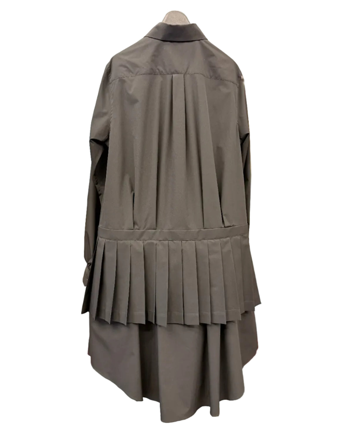 Back view of noir kei ninomiya black shirt dress showing structured knife pleats and layered hem