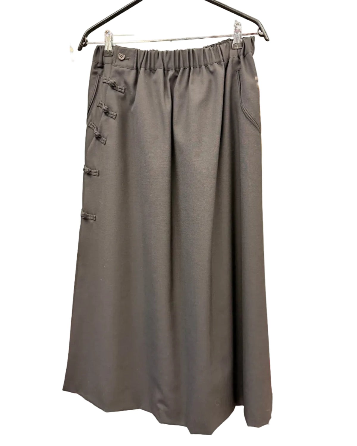 Front view of noir kei ninomiya black wool skirt with elasticated waist and fabric toggle details