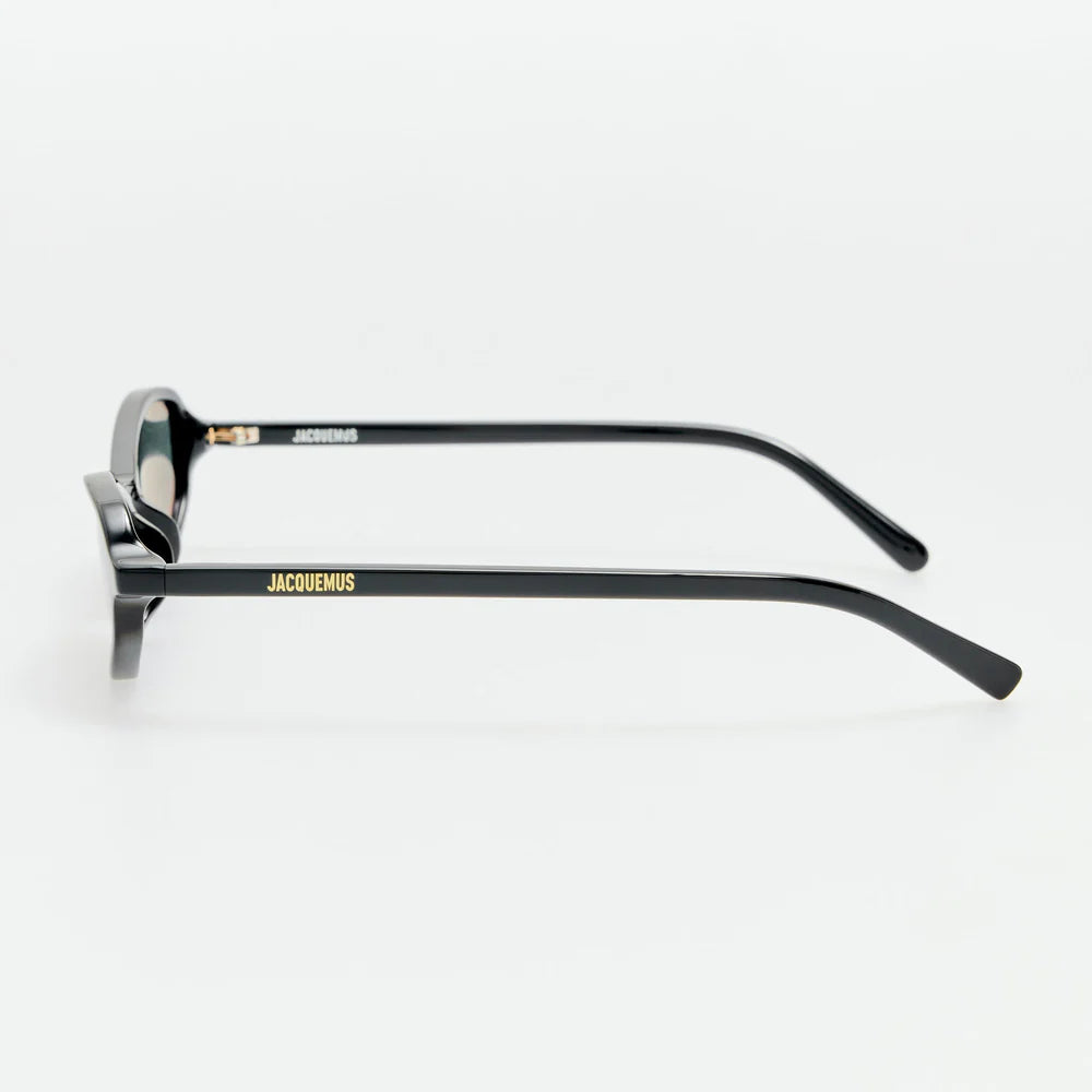 Side view of Jacquemus Pina sunglasses showing black temples and gold-tone logo