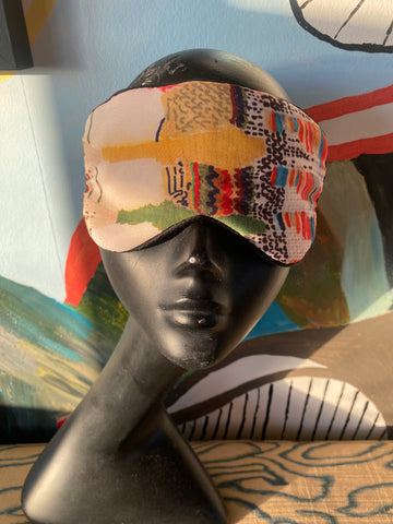 Kron by Kronkron silk sleep mask in Daydream print displayed on a black mannequin head