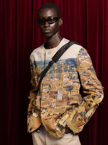 Campaign image
Junya Watanabe Man Distressed Cityscape Knit Jacket in beige worn with a crossbody strap against a red backdrop