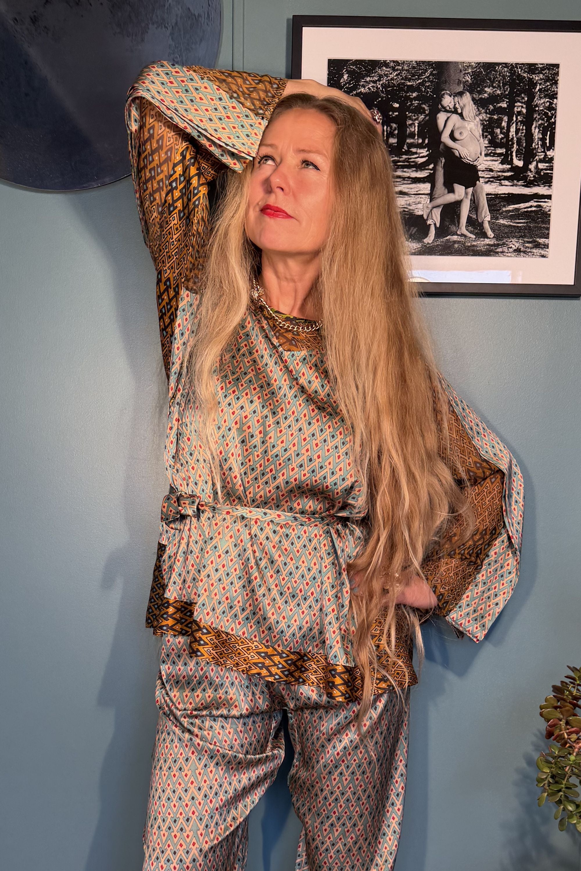 Close-up of Josephine Sporrof Blue silk blouse with wide contrast sleeves and tie belt