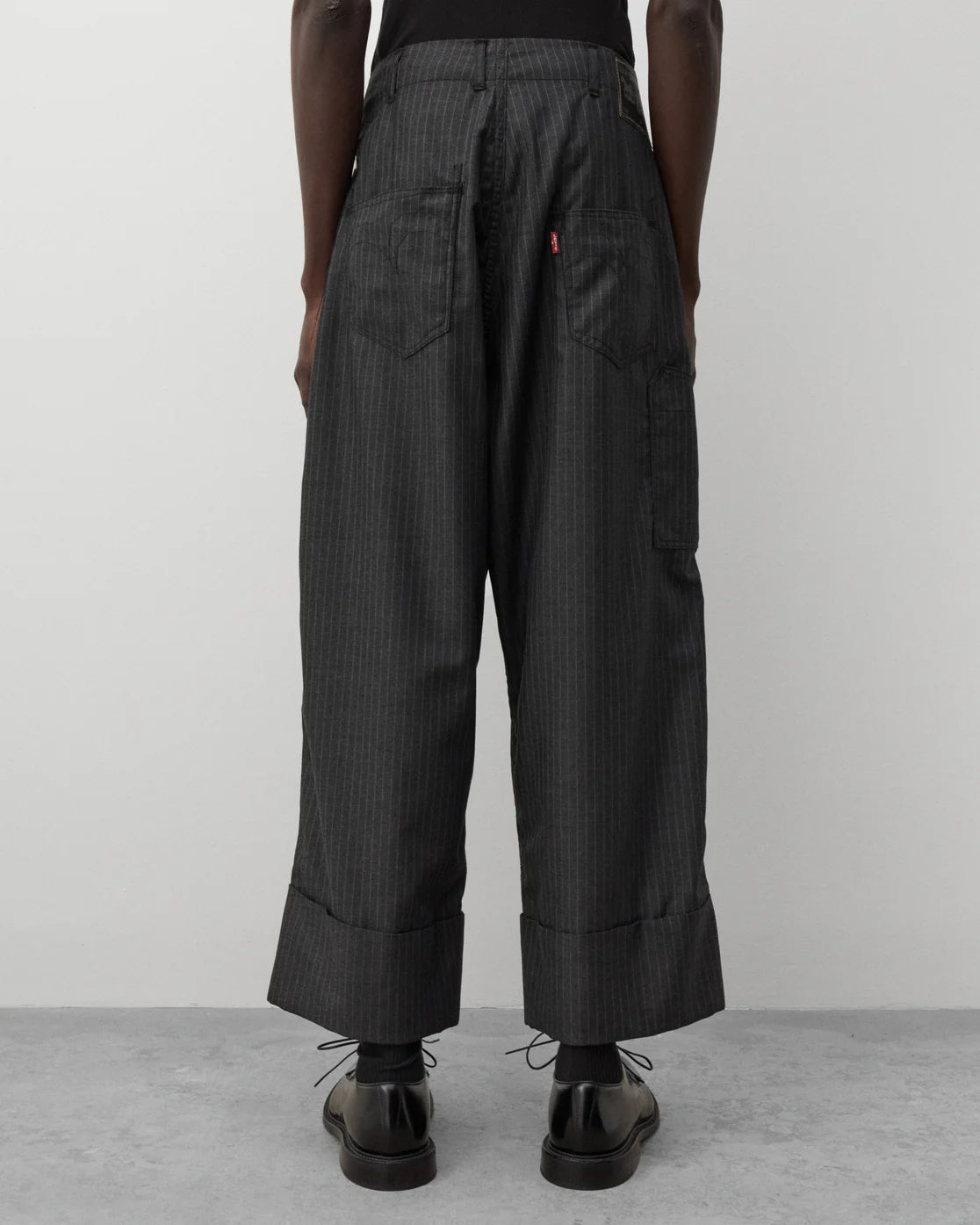 Back worn
Junya Watanabe Man Levi’s Pinstripe Trousers in grey shown from the back with Levi’s tab detail