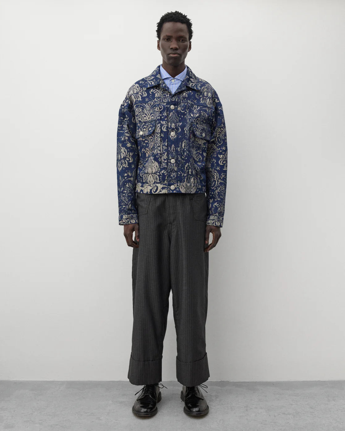 Full look
Junya Watanabe Man Levi’s Pinstripe Trousers in grey styled with a blue jacquard jacket and black leather shoes