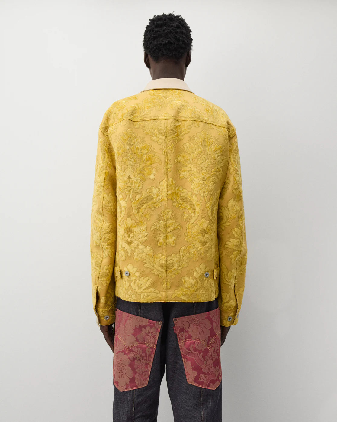 Back worn
Junya Watanabe Man Floral Pattern Jacket in yellow shown from the back with adjustable button tabs