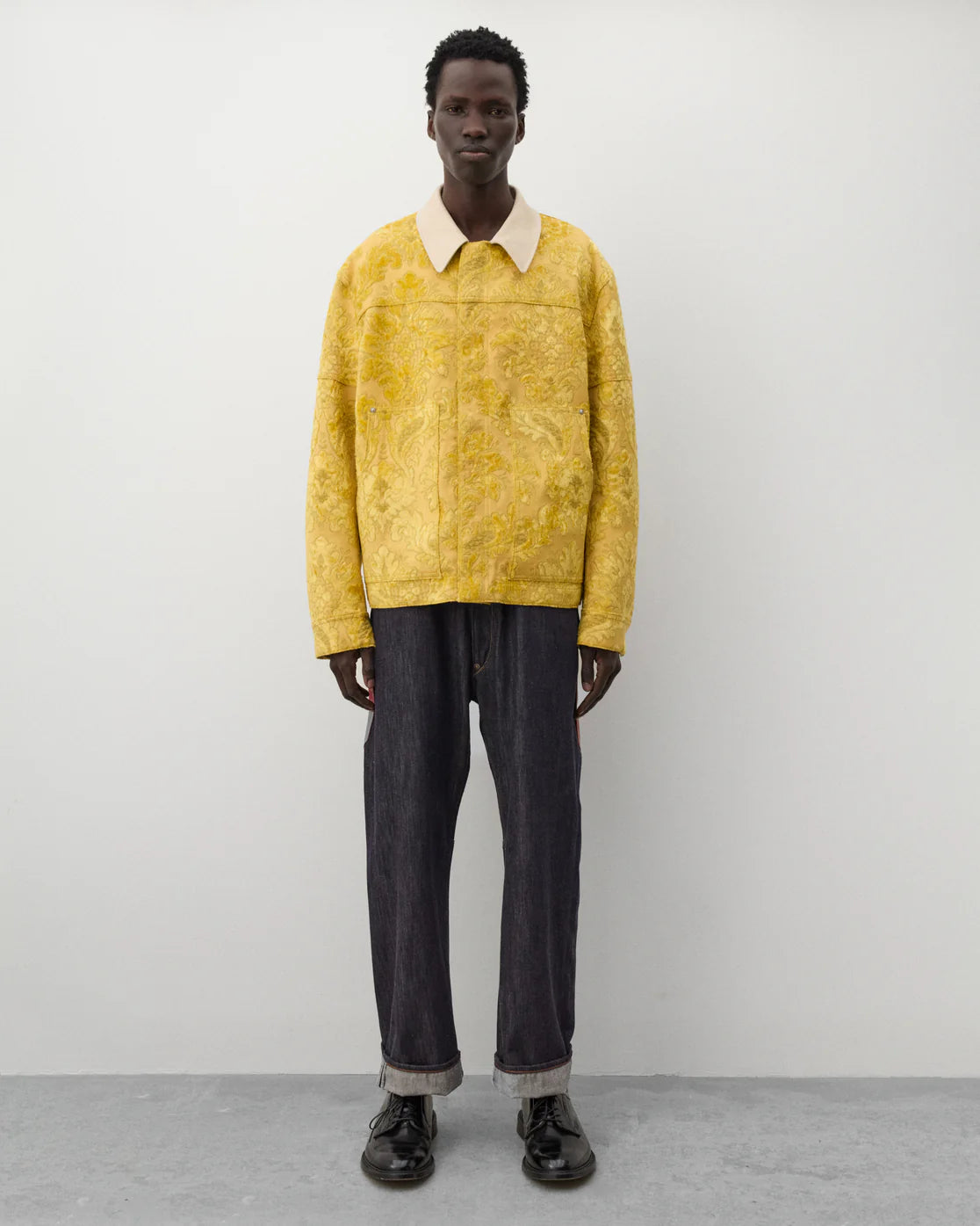 Full look
Junya Watanabe Man Floral Pattern Jacket in yellow styled with dark denim and black leather shoes