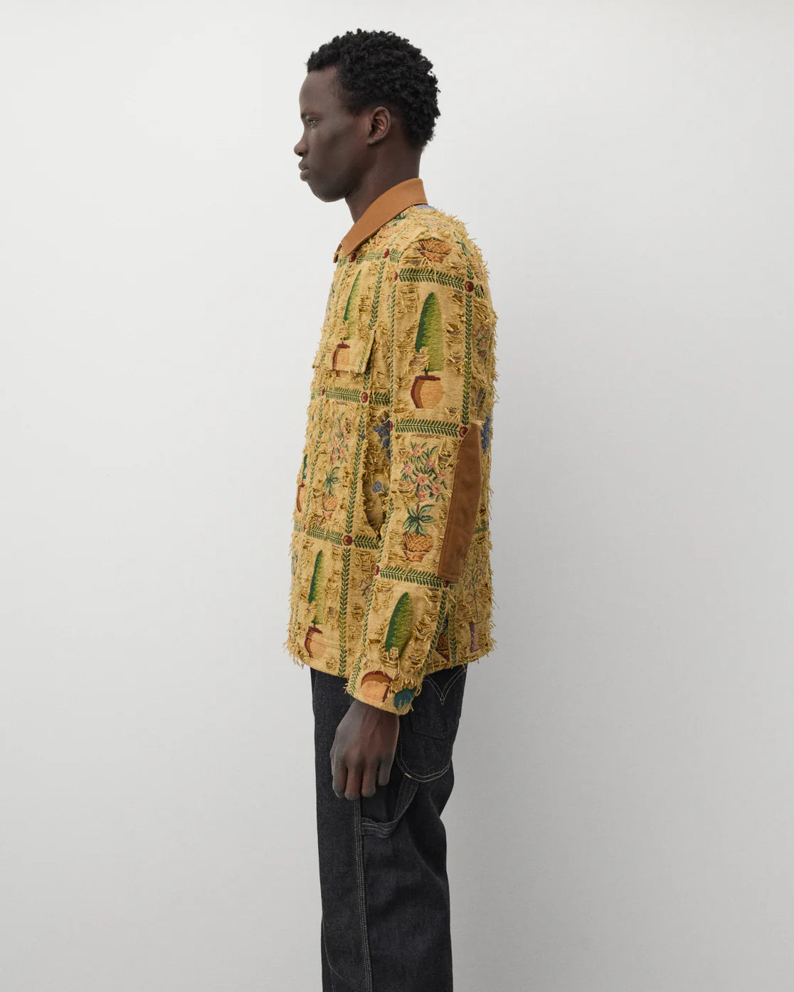 Worn side
Junya Watanabe Man Plant Pot Tapestry Jacket in brown shown from the side with elbow patch detail