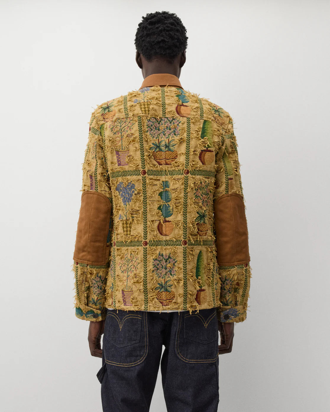 Worn back
Junya Watanabe Man Plant Pot Tapestry Jacket in brown shown from the back with contrast elbow patches
