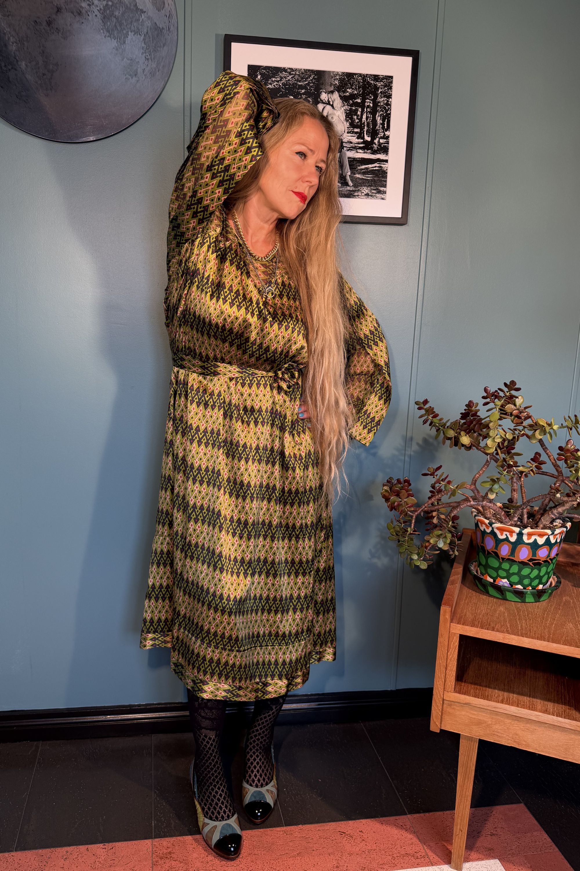 Josephine Sporrof Green silk dress by Kron by Kronkron shown in a relaxed side pose