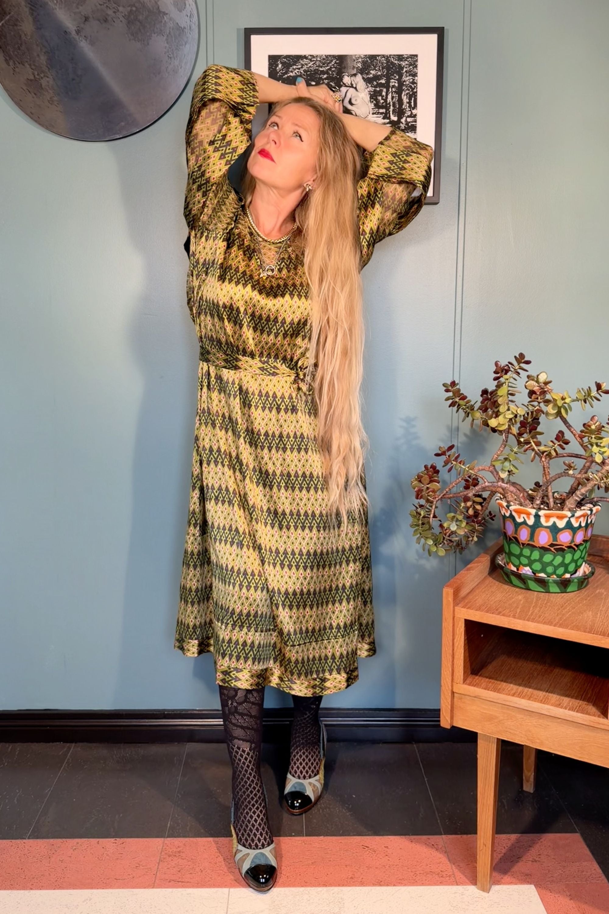 Woman wearing the Josephine silk satin dress in Sporrof Green print by Kron by Kronkron, front view with waist belt