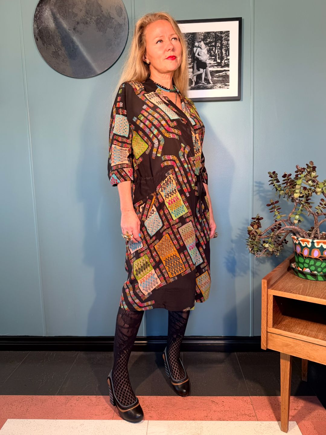 Three-quarter view of Rimini silk midi dress in Black Harly showing the fluid silhouette and geometric print