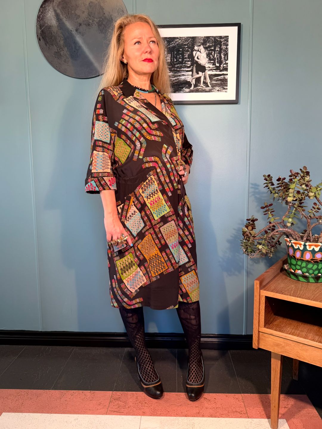 Rimini Black Harly silk dress styled with matching printed trousers, showing the relaxed midi silhouette