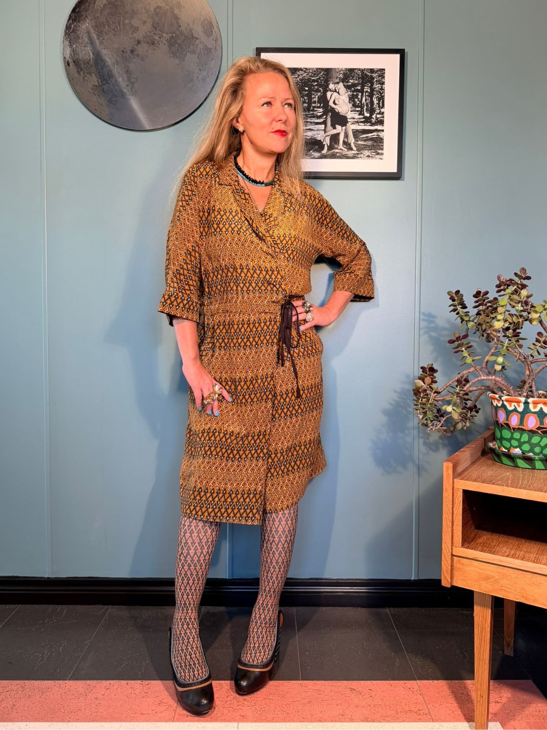 Front three-quarter view of Kron by Kronkron Rimini silk midi dress in Sporrof Gold with crossover neckline and adjustable waist tie
