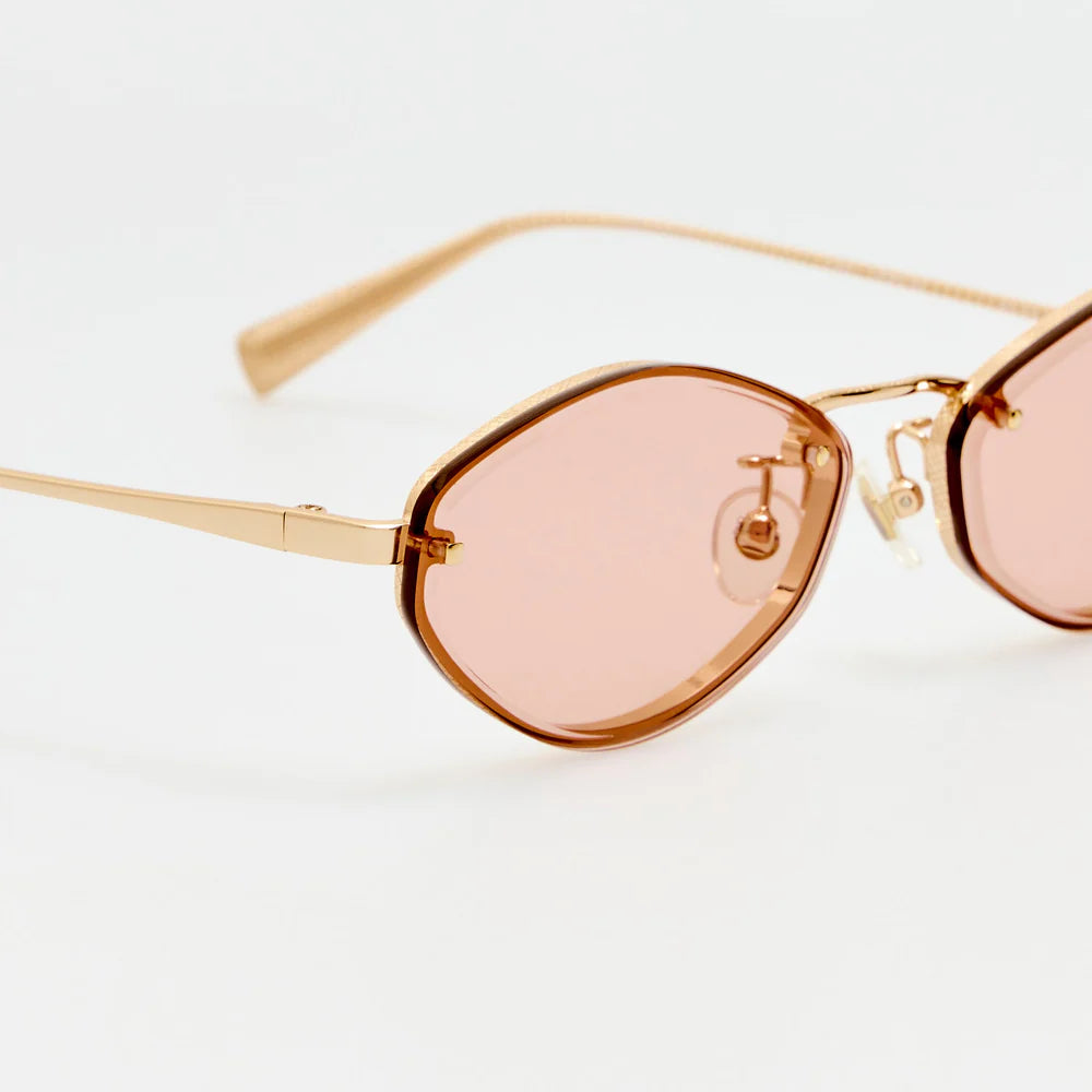 Close-up of Jacquemus Bellini sunglasses with blush lenses, etched rims and adjustable nose pads