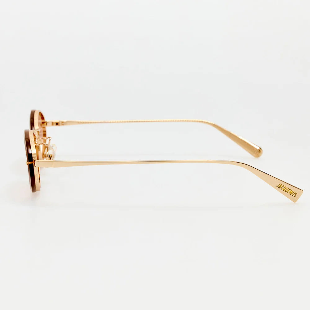 Side view of Jacquemus Bellini sunglasses showing slim light gold temples