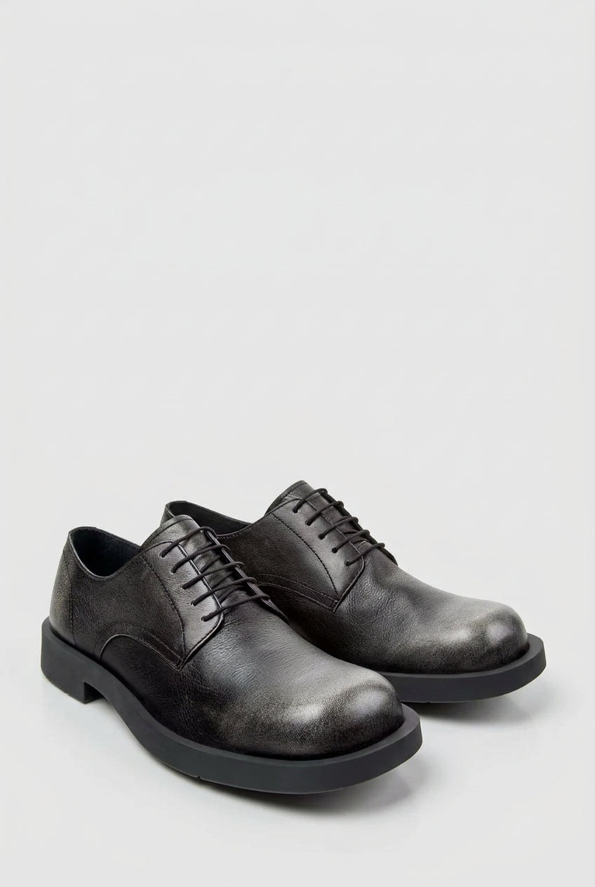 Angled view of CamperLab MIL 1978 black and white leather lace-up shoes
