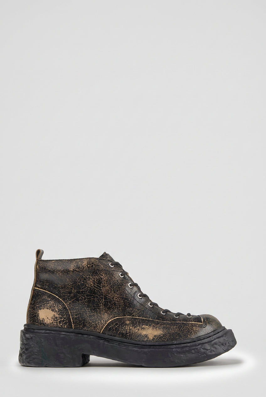 Side view of CamperLab Vamonos black and brown leather ankle boots