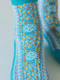 Tabio Sicilian Pattern Low Crew Socks in blue with multicolour Sicilian-inspired pattern worn on the foot