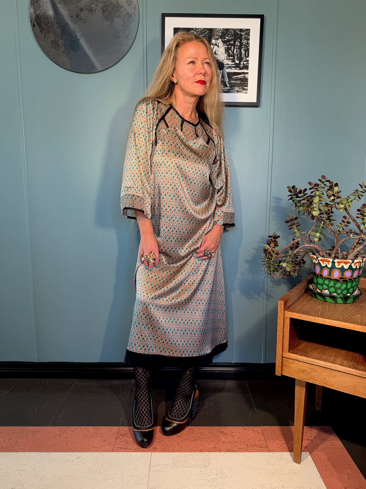 Jacqueline silk dress in Sporrof Blue showing the movement of the silk, geometric pattern and black contrast hem