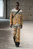 Runway image
Junya Watanabe Man Distressed Cityscape Knit Jacket in beige worn on the runway with matching textured trousers