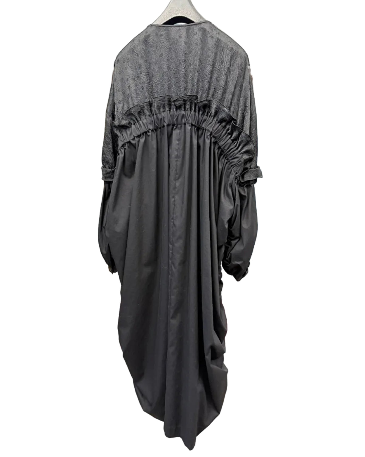 Back view of noir kei ninomiya black long dress showing gathered ruffle detail and relaxed silhouette