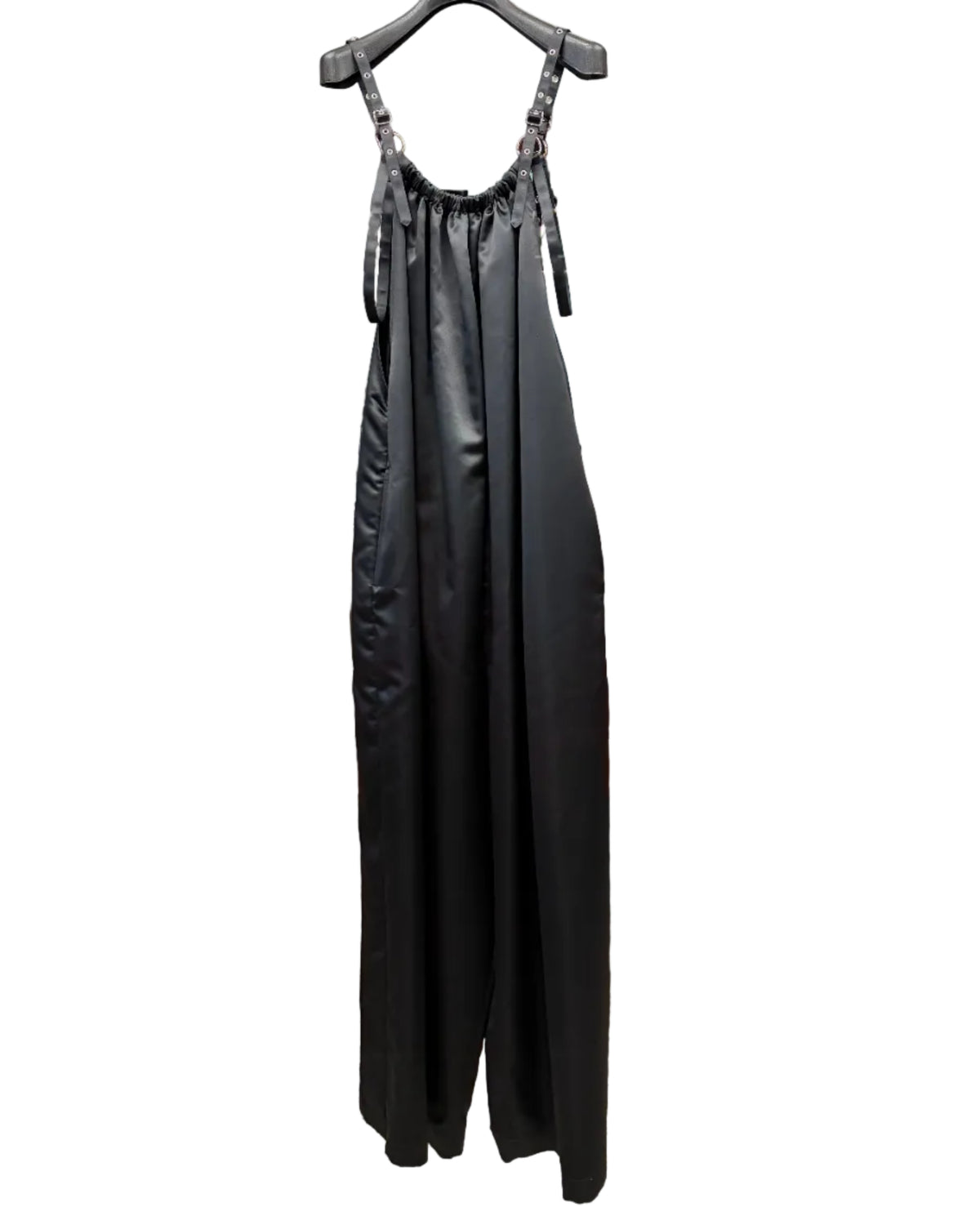 Back view of noir kei ninomiya black satin wide-leg jumpsuit with adjustable buckle straps