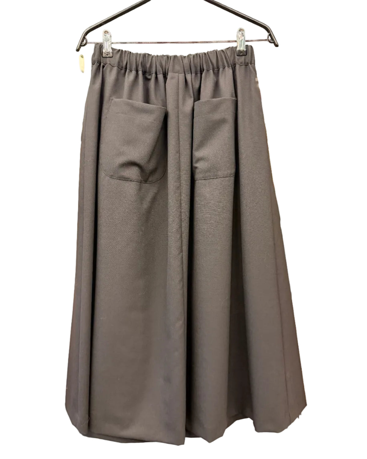 Back view of noir kei ninomiya black wool skirt with two patch pockets and relaxed long silhouette