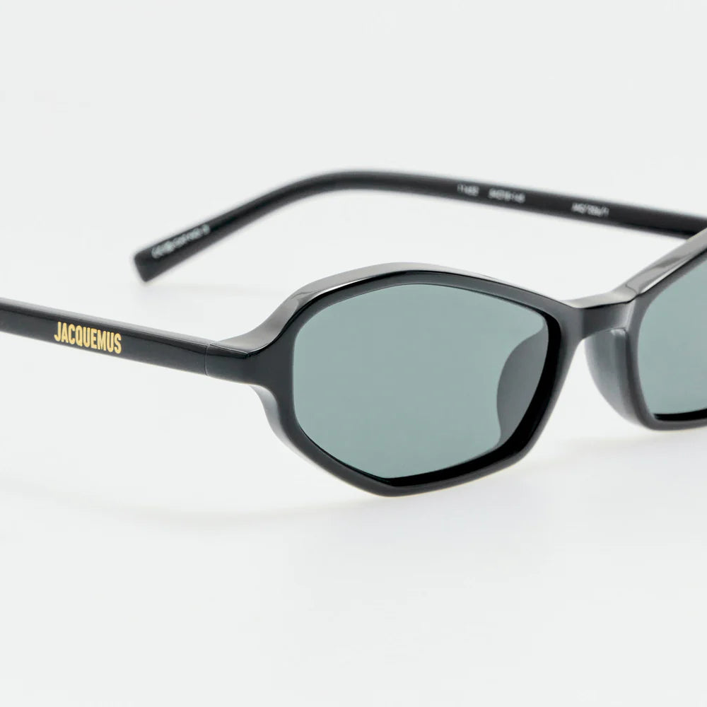 Close-up of Jacquemus Pina black acetate frame, grey lens and gold-tone branding